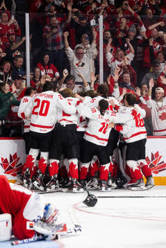 Players of Canada celebrate the game winning goal 2-3
