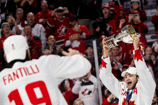 Shane Wright of Canada celebrates with the trophy