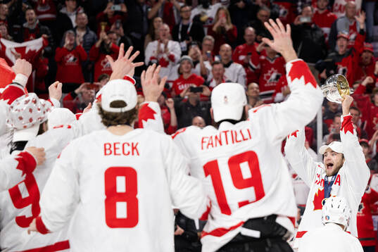 Shane Wright of Canada celebrates with the trophy
