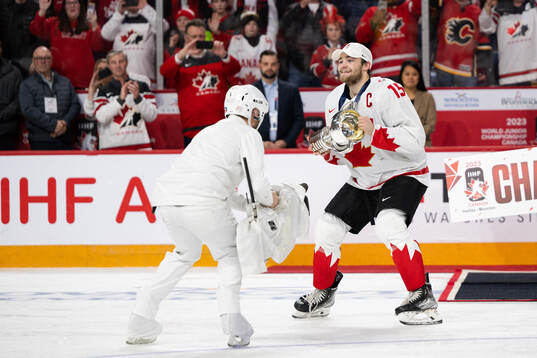 Shane Wright of Canada celebrates with the trophy