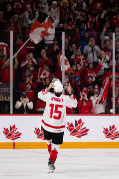 Shane Wright of Canada celebrates with the trophy