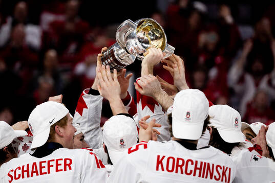 Players of Canada celebrate with the trophy