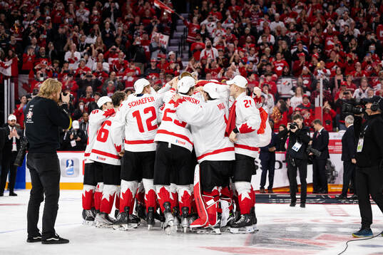 Players of Canada celebrate with the trophy