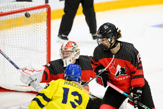 Mira Hallin of Sweden and goaltender Hannah Clark and Ava