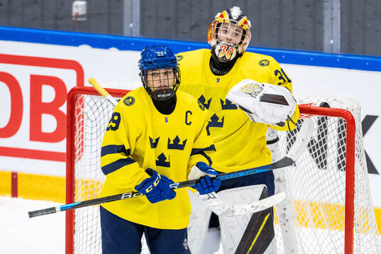 Stella Lindell and goaltender Felicia Frank of Sweden looks