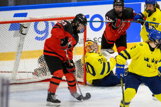 Caitlin Kraemer of Canada scores 2-3 behind goaltender