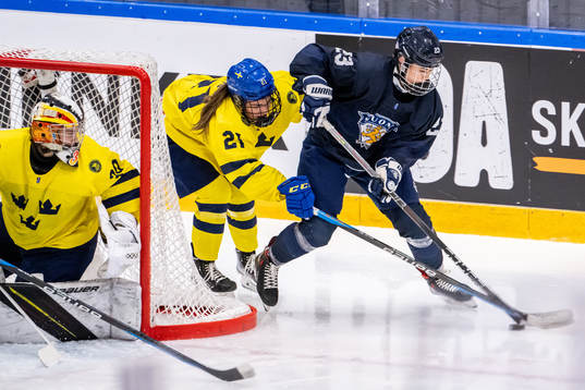 Erica Korhonen of Finland against Emma Rehn and goaltender