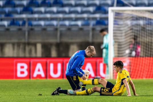 Yasin Ayari of Sweden receives medical attention