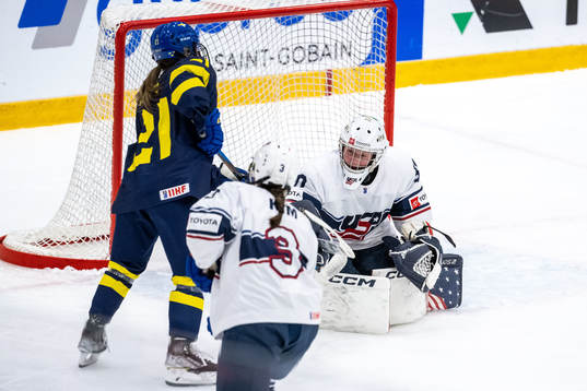 Emma Rehn of Sweden and goaltender Annelies Bergmann of USA