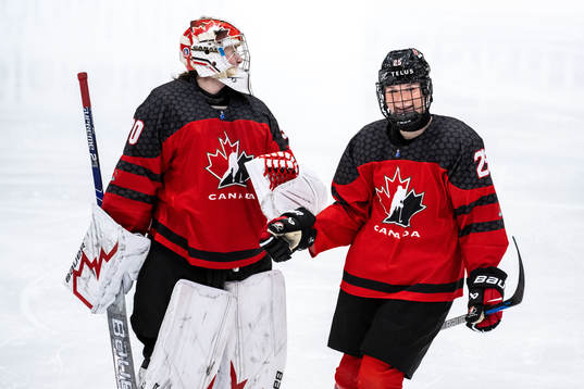 Goaltender Hannah Clarkand Gracie Graham celebrate
