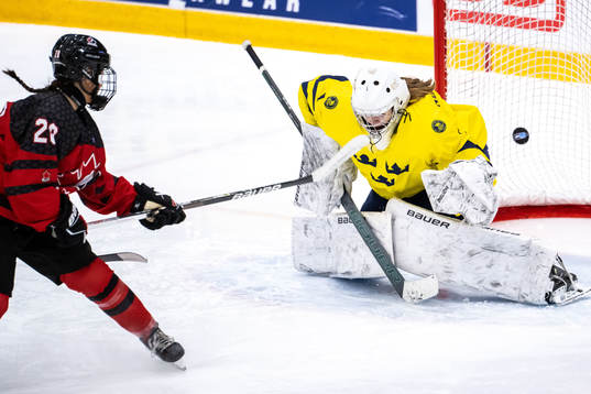 Abby Lunney of Canada and goaltender Ida Henriksson of