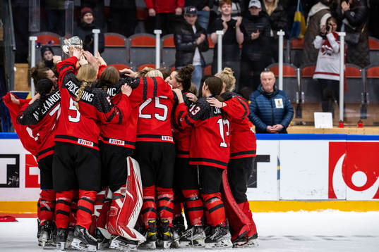 Players of Canada celebrate with the trophy