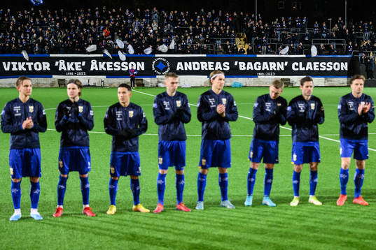Tv åavkidna supportrar hedras med en applåd och banderoll