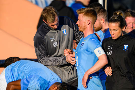 Physiotherapist Jesper Robertsson looks over Anders