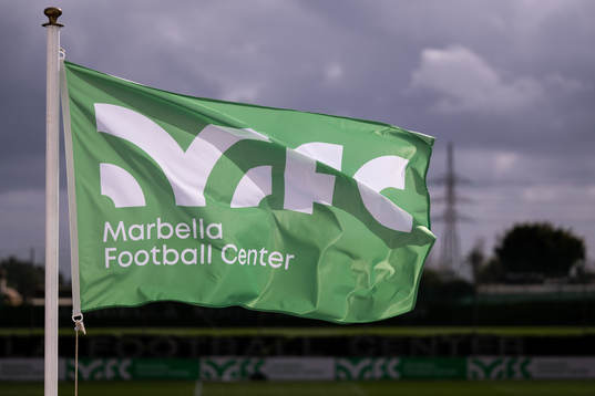 Flags with the Marbella Football Center logo