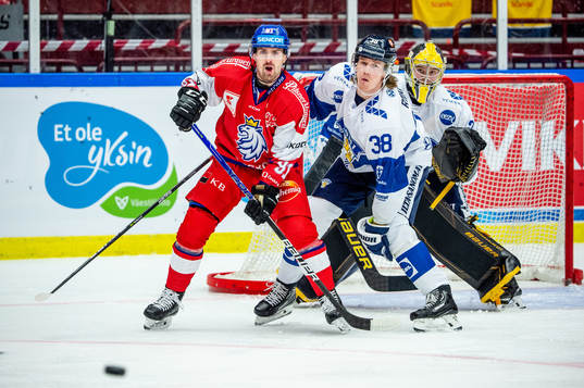 Jakub Flek of Czechia and Juuso Riikola and goaltender Juha