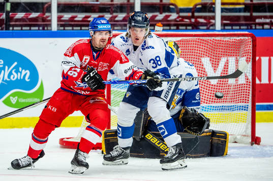 Jakub Flek of Czechia and Juuso Riikola and goaltender Juha