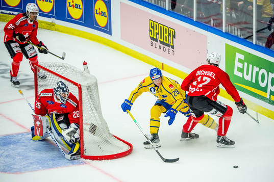Anton Bengtsson of Sweden and goaltender Sandro Aeschlimann