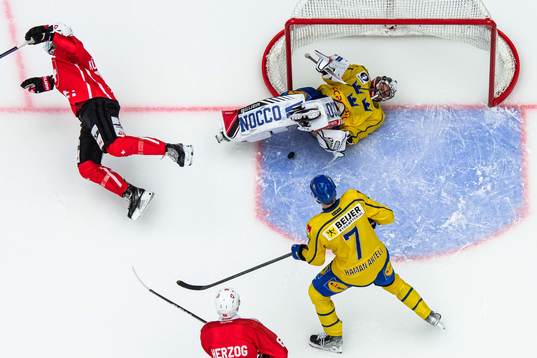 Mike Kunzle of Switzerland and goalkeeper Jhonas Enroth of