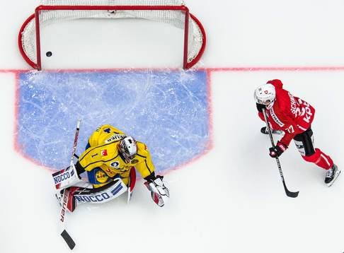 Goalkeeper Jhonas Enroth of Sweden and Sandro Schmid of
