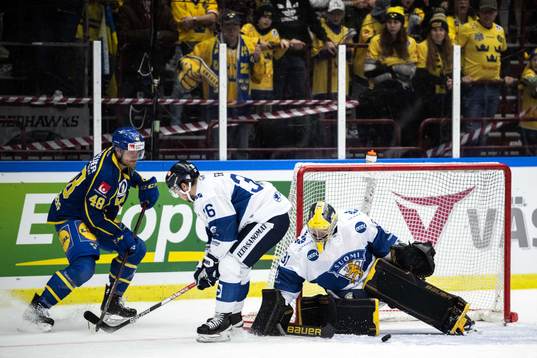 Carl Klingberg of Sweden and goaltender Juha Jatkola of