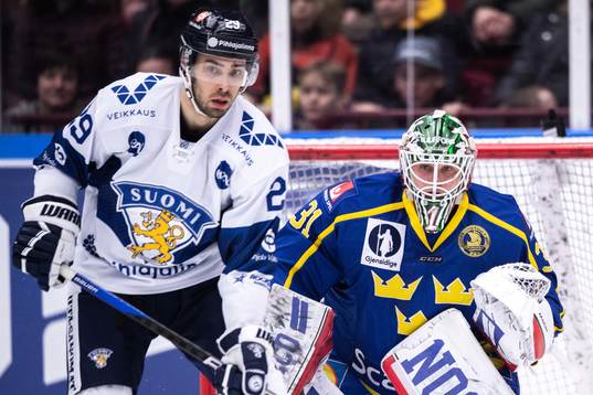 Ahti Oksanen of Finland and goaltender Lars Johansson of
