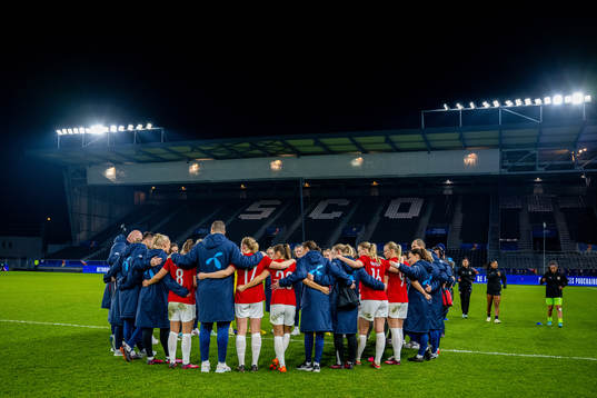 Players and staff of Norway gather in a circle