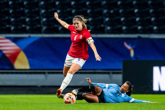 Maren Mjelde of Norway and Carolina Birizamberri of Uruguay
