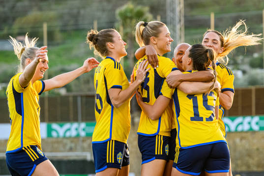 Johanna Rytting Kaneryd is hugged by her teammates of Sweden