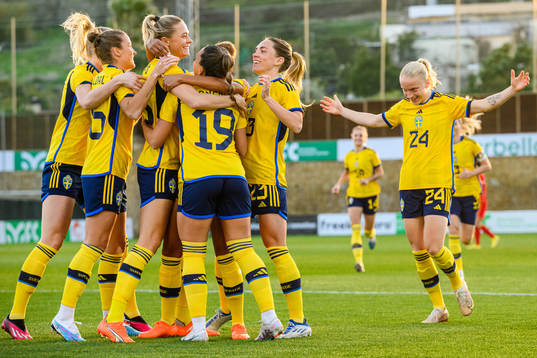 Johanna Rytting Kaneryd is hugged by her teammates of Sweden