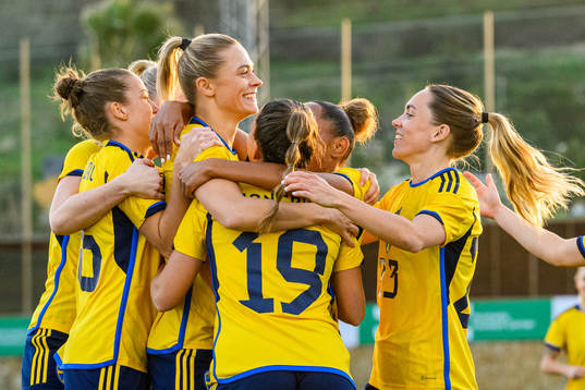 Johanna Rytting Kaneryd is hugged by her teammates of Sweden