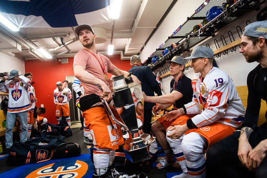 Tappara players celebrates with trophy in the locker room