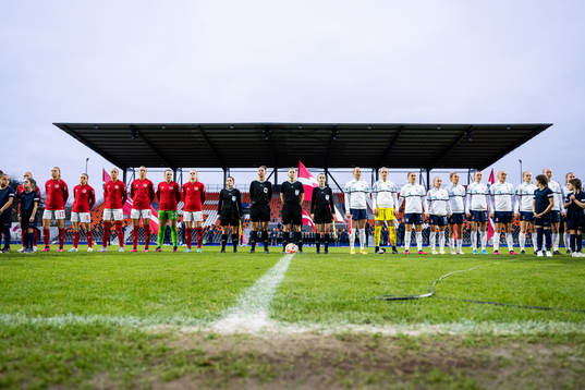 Players of Denmark and Norway line up