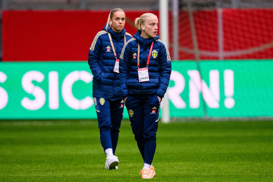 Hanna Lundkvist and Anna Sandberg of Sweden walks the pitch