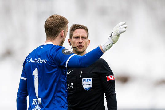 Egil Selvik of Haugesund and Espen Andreas Eskås, referee