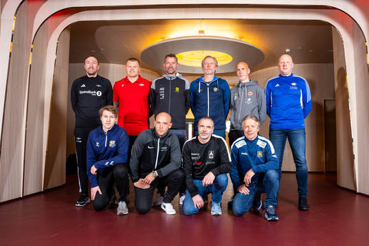 Head coaches pose for a team photo