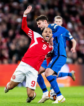 Martin Braithwaite of Denmark and Kaan Kairinen of Finland