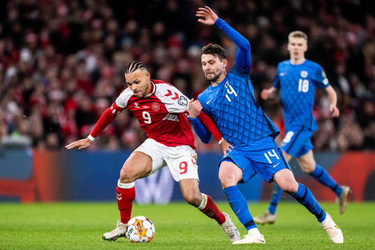 Martin Braithwaite of Denmark and Kaan Kairinen of Finland