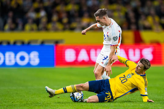 Leandro Trossard of Belgium and Kristoffer Olsson of Sweden