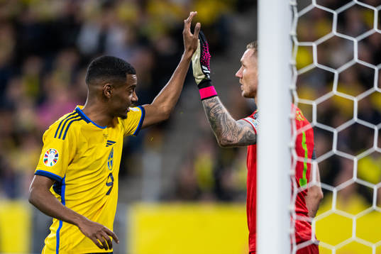 Alexander Isak and goalkeeper Robin Olsen of Sweden