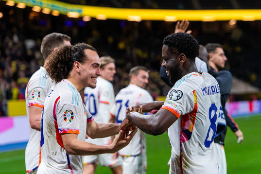 Arthur Theate and Orel Mangala of Belgium celebrate