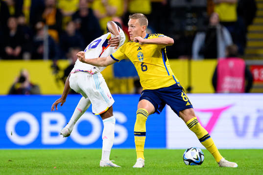Dodi Lukebakio of Belgium and Ludvig Augustinsson of Sweden