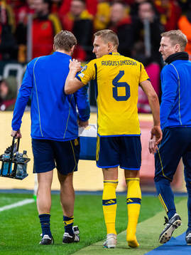 Ludvig Augustinsson of Sweden leaves the pitch due to injury