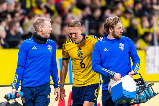 Ludvig Augustinsson of Sweden leaves the pitch due to injury