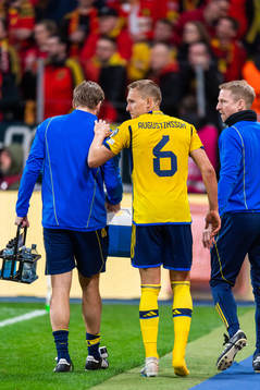 Ludvig Augustinsson of Sweden leaves the pitch due to injury