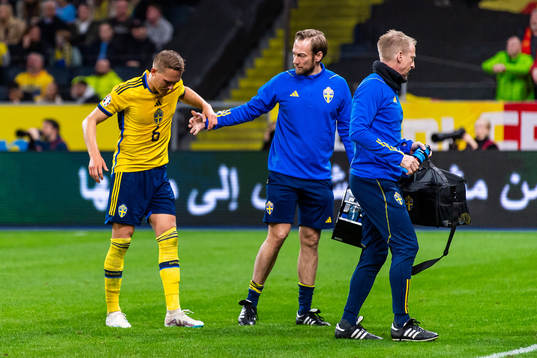 Ludvig Augustinsson of Sweden leaves the pitch due to injury