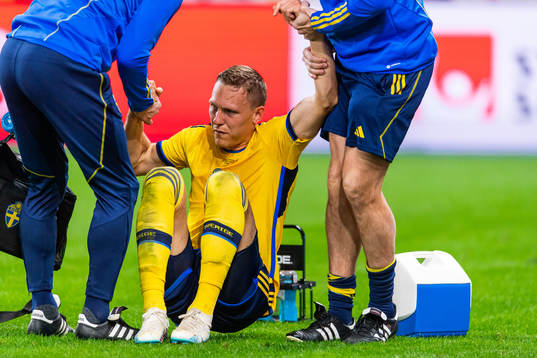Ludvig Augustinsson of Sweden leaves the pitch due to injury