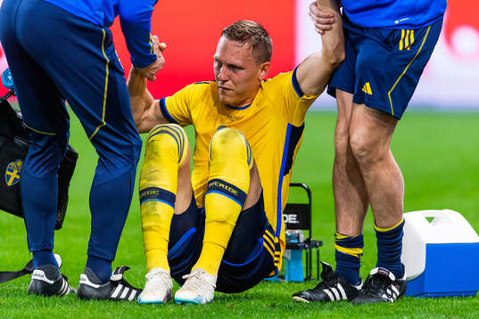 Ludvig Augustinsson of Sweden leaves the pitch due to injury