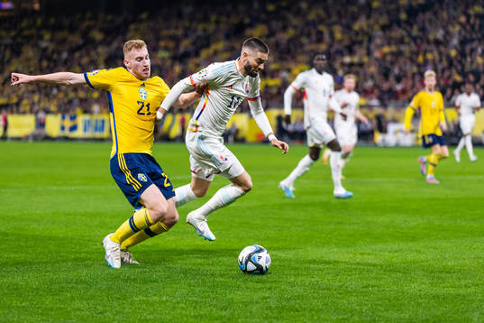 Dejan Kulusevski of Sweden and Yannick Carrasco of Belgium