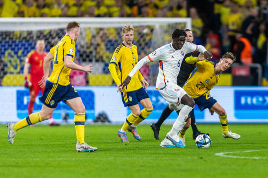 Amadou Onana of Belgium and Kristoffer Olsson of Sweden